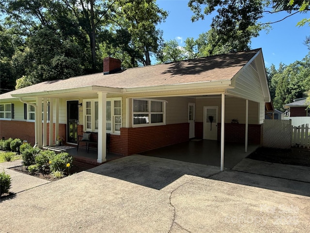 708 E St Unit 8, 9, Albemarle, NC 28001 - ranch-style house with brick siding, driveway, a porch, a chimney, and a carport