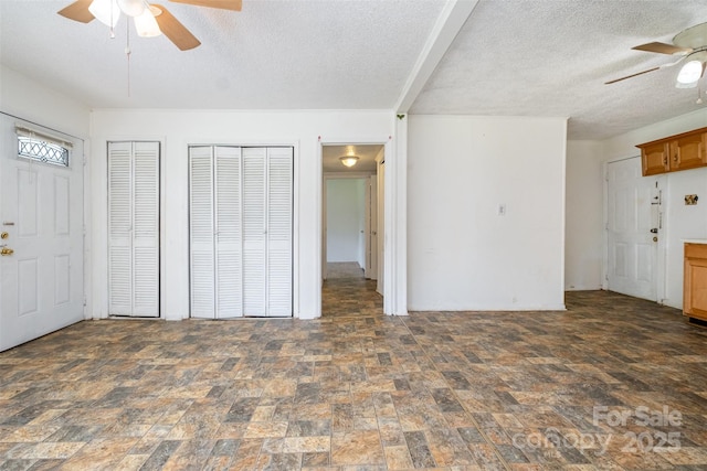 1043 Sid Davis Rd, Chester, SC 29706 - unfurnished living room with ceiling fan, stone finish flooring, and a textured ceiling