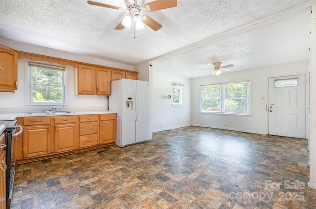 1043 Sid Davis Rd, Chester, SC 29706 - kitchen with white fridge with ice dispenser, a ceiling fan, a textured ceiling, healthy amount of natural light, and light countertops