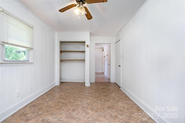 1043 Sid Davis Rd, Chester, SC 29706 - unfurnished bedroom featuring a ceiling fan, multiple closets, and wood walls