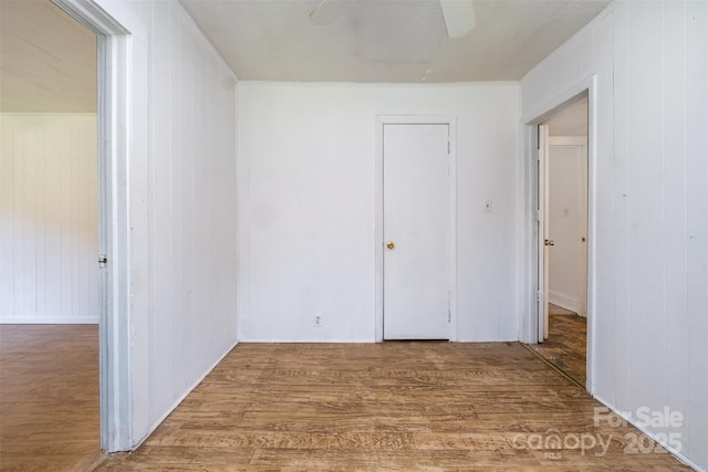 1043 Sid Davis Rd, Chester, SC 29706 - unfurnished bedroom with wood finished floors, wood walls, and a ceiling fan