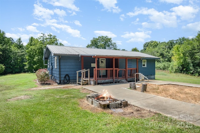 1043 Sid Davis Rd, Chester, SC 29706 - rear view of house with an outdoor fire pit, a yard, and a metal roof