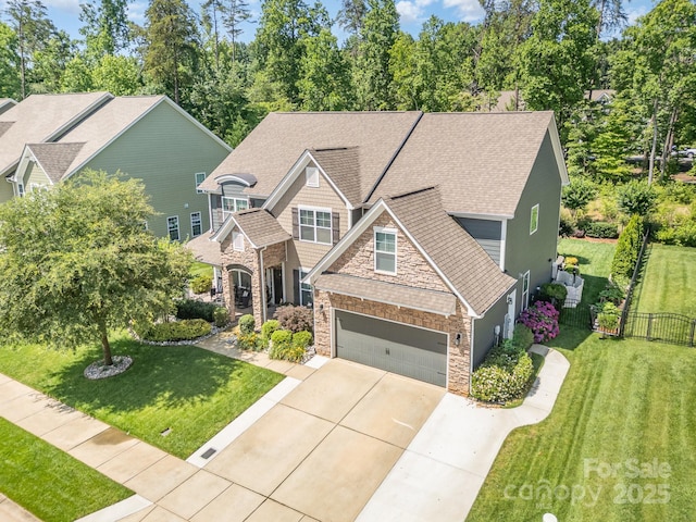 183 Canoe Pole Ln, Mooresville, NC 28117 - craftsman house with concrete driveway, stone siding, a shingled roof, and a garage