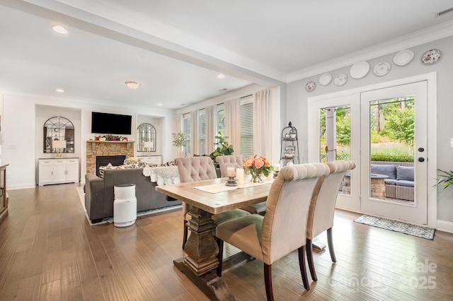 183 Canoe Pole Ln, Mooresville, NC 28117 - dining space featuring plenty of natural light, ornamental molding, hardwood / wood-style floors, a fireplace, and recessed lighting