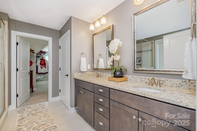 183 Canoe Pole Ln, Mooresville, NC 28117 - full bath featuring double vanity, a shower stall, a spacious closet, and tile patterned flooring