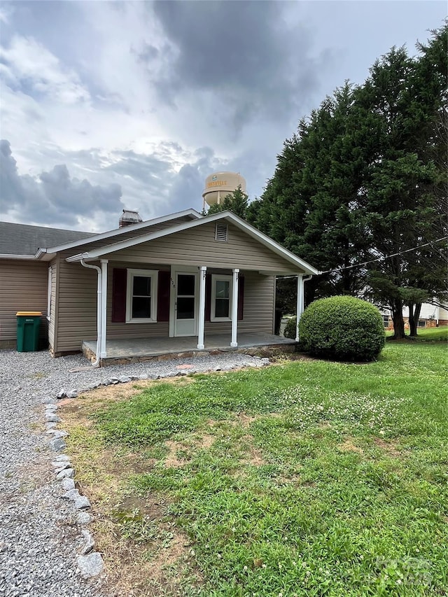 628 Main St S, Jonesville, NC 29353 - view of front of property with a porch, a front yard, and a chimney