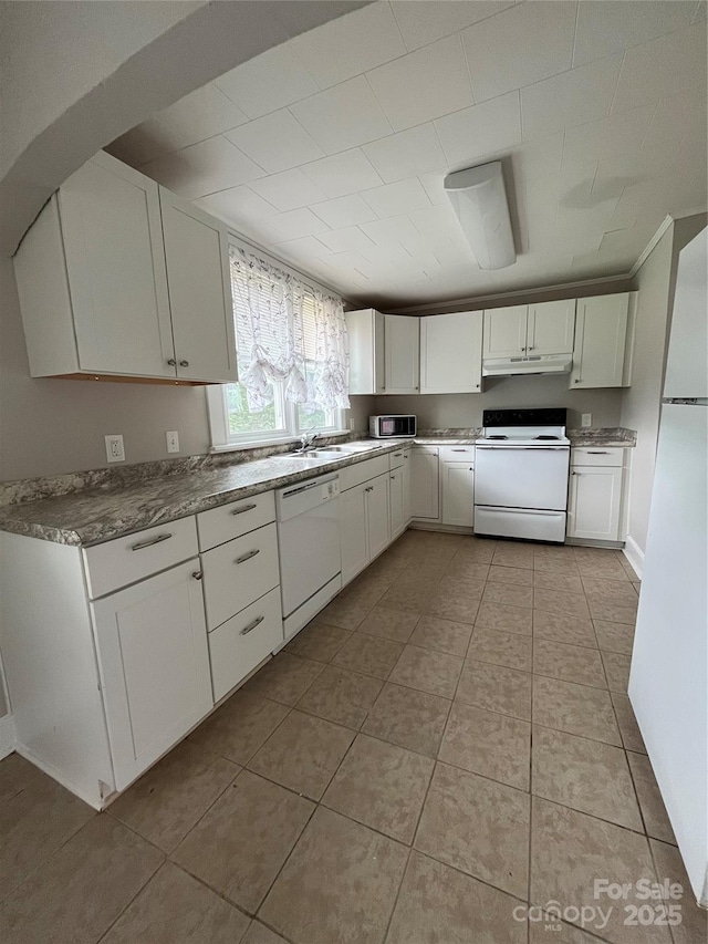 628 Main St S, Jonesville, NC 29353 - kitchen with white appliances, under cabinet range hood, white cabinets, and light tile patterned flooring
