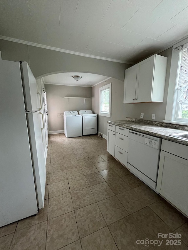 628 Main St S, Jonesville, NC 29353 - kitchen with white appliances, washer and dryer, ornamental molding, white cabinets, and arched walkways