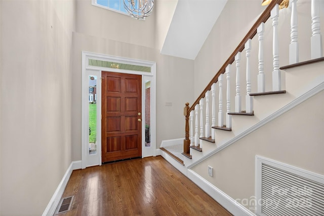 803 Woodmoore Ln, Kannapolis, NC 28081 - foyer entrance with wood finished floors, a high ceiling, stairs, and a chandelier