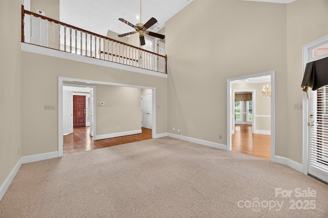 803 Woodmoore Ln, Kannapolis, NC 28081 - unfurnished living room with carpet, high vaulted ceiling, a ceiling fan, and a chandelier