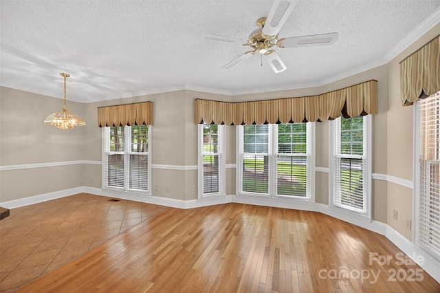 803 Woodmoore Ln, Kannapolis, NC 28081 - unfurnished room with a textured ceiling, a chandelier, light wood-style flooring, a ceiling fan, and ornamental molding