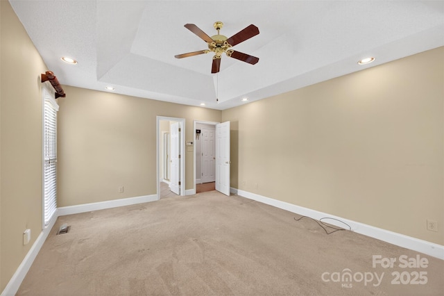803 Woodmoore Ln, Kannapolis, NC 28081 - unfurnished bedroom featuring light colored carpet, a tray ceiling, recessed lighting, ceiling fan, and ensuite bathroom