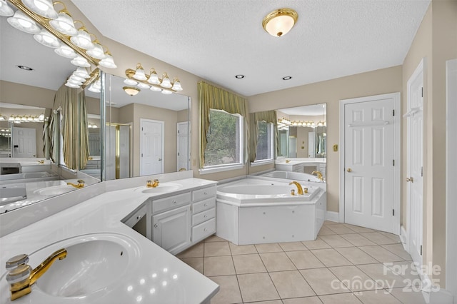 803 Woodmoore Ln, Kannapolis, NC 28081 - bathroom featuring a bath, vanity, tile patterned floors, a shower stall, and a textured ceiling