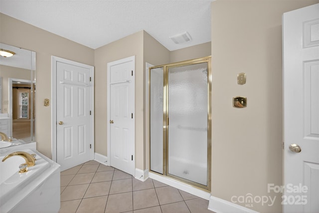 803 Woodmoore Ln, Kannapolis, NC 28081 - bathroom featuring a shower stall, tile patterned floors, a tub, and a textured ceiling