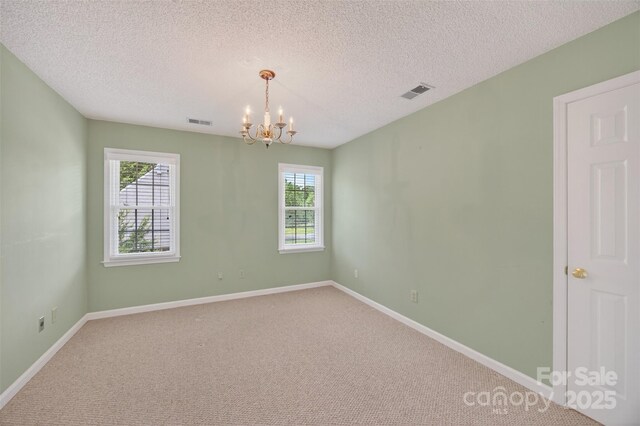 803 Woodmoore Ln, Kannapolis, NC 28081 - carpeted spare room featuring a chandelier and a textured ceiling