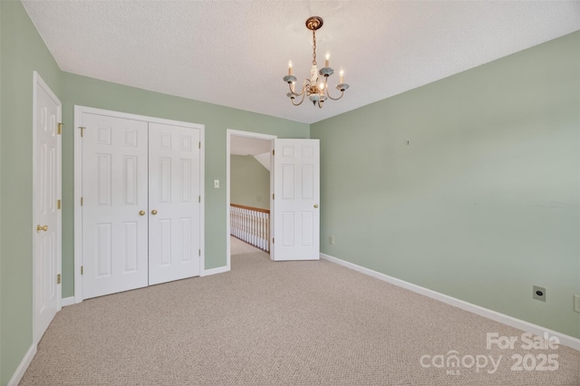 803 Woodmoore Ln, Kannapolis, NC 28081 - unfurnished bedroom with a chandelier, carpet, a closet, and a textured ceiling