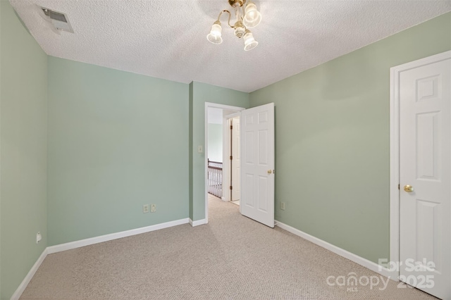 803 Woodmoore Ln, Kannapolis, NC 28081 - unfurnished bedroom with light carpet, a textured ceiling, and a chandelier