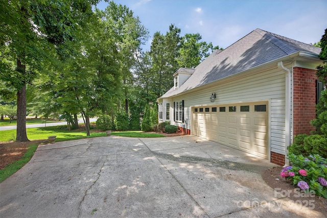 803 Woodmoore Ln, Kannapolis, NC 28081 - view of side of property featuring driveway, brick siding, a garage, and roof with shingles