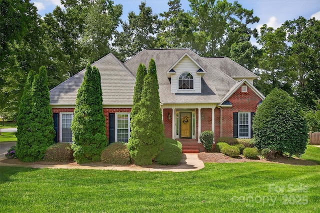 803 Woodmoore Ln, Kannapolis, NC 28081 - traditional-style home with brick siding, a front lawn, and a shingled roof