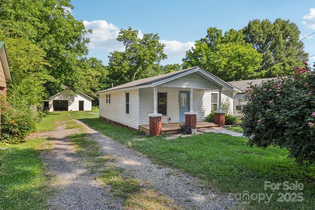1626 W Park Ave, Albemarle, NC 28001 - bungalow-style home featuring covered porch, driveway, a front yard, and an outbuilding