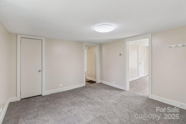 1626 W Park Ave, Albemarle, NC 28001 - unfurnished bedroom with carpet floors and a textured ceiling