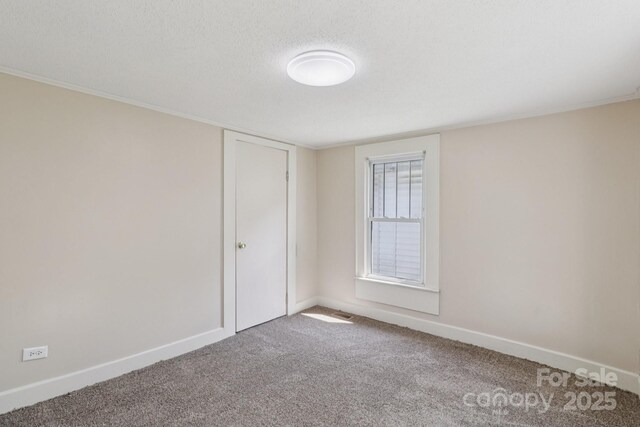 1626 W Park Ave, Albemarle, NC 28001 - carpeted spare room with a textured ceiling and baseboards