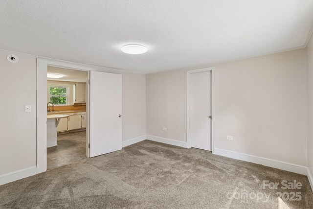1626 W Park Ave, Albemarle, NC 28001 - carpeted spare room with a textured ceiling