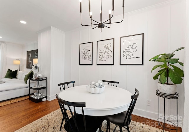 504 Wakefield Dr Unit A, Charlotte, NC 28209 - dining area with a decorative wall, a chandelier, wood finished floors, recessed lighting, and crown molding