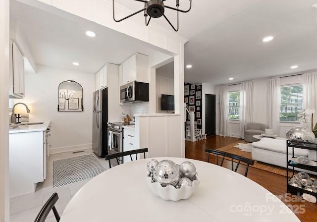 504 Wakefield Dr Unit A, Charlotte, NC 28209 - dining area with recessed lighting, dark wood-type flooring, a chandelier, and a ceiling fan