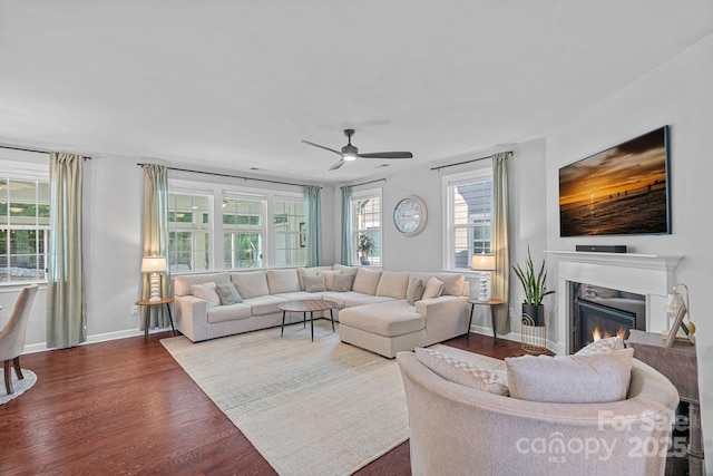 1335 Bryson Gap Dr, Fort Mill, SC 29715 - living room with dark wood finished floors, a ceiling fan, and a glass covered fireplace