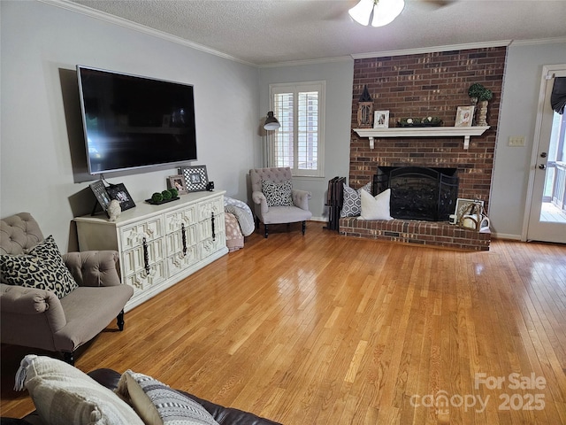 217 Rock Creek Dr, Lincolnton, NC 28092 - living room with hardwood / wood-style floors, a textured ceiling, ornamental molding, and a fireplace