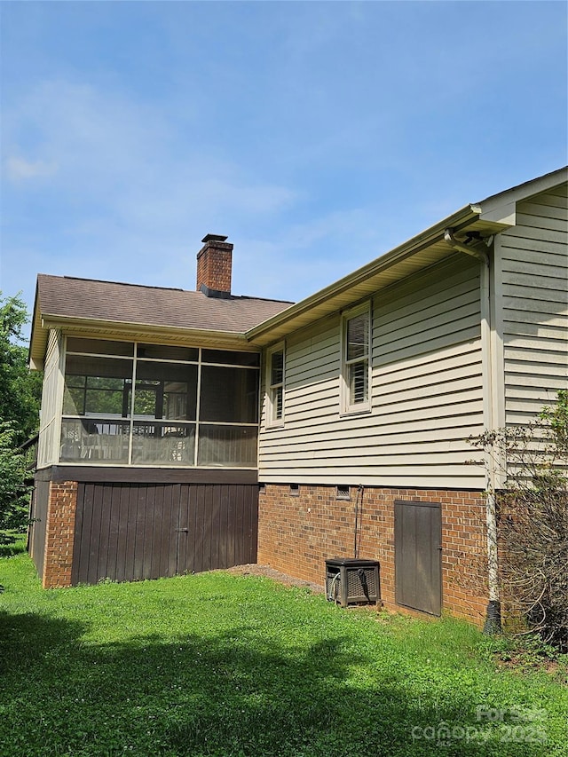 217 Rock Creek Dr, Lincolnton, NC 28092 - back of house featuring a sunroom, crawl space, a yard, and a chimney
