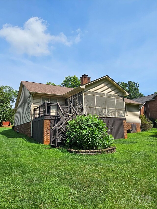 217 Rock Creek Dr, Lincolnton, NC 28092 - back of house featuring a sunroom, a chimney, a lawn, and stairway