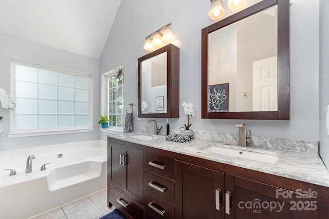 11624 Crossroads Pl, Concord, NC 28025 - bathroom featuring vaulted ceiling, double vanity, a garden tub, and tile patterned floors