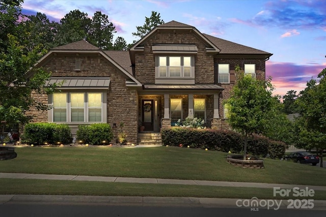 16402 Doves Canyon Ln, Charlotte, NC 28278 - craftsman inspired home featuring stone siding, a yard, a standing seam roof, and roof with shingles
