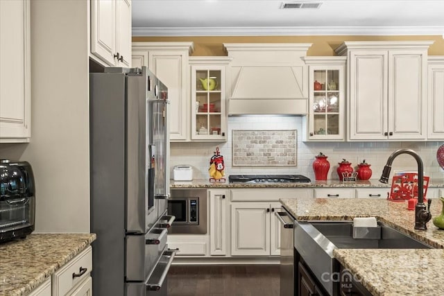 16402 Doves Canyon Ln, Charlotte, NC 28278 - kitchen with stainless steel appliances, premium range hood, backsplash, ornamental molding, and dark wood-type flooring