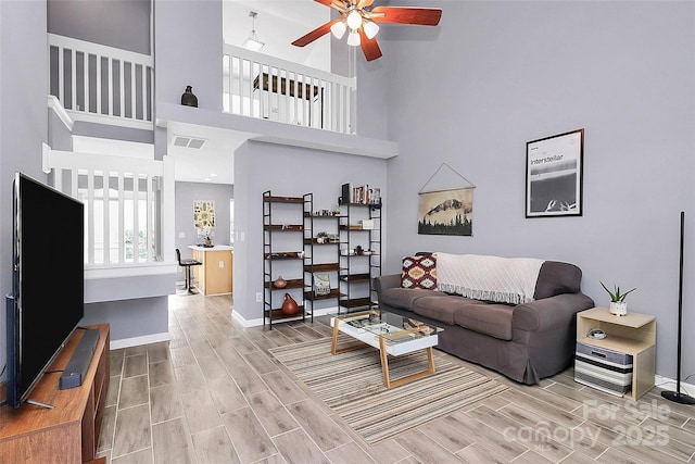 5980 Cougar Ln, Charlotte, NC 28269 - living room with wood finish floors, ceiling fan, and a high ceiling