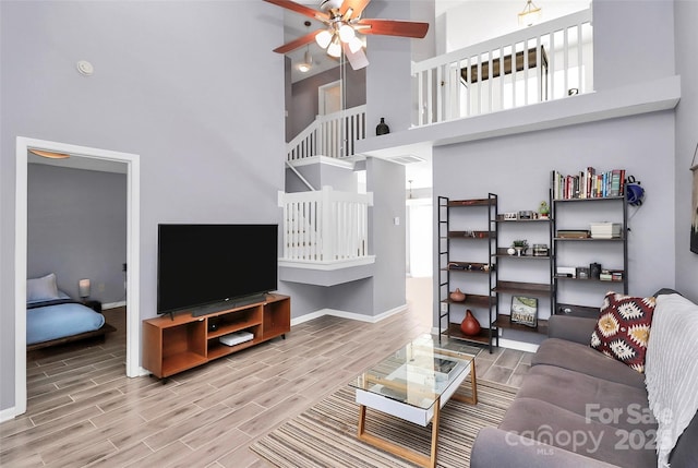 5980 Cougar Ln, Charlotte, NC 28269 - living room featuring a high ceiling, wood tiled floors, and ceiling fan