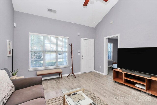 5980 Cougar Ln, Charlotte, NC 28269 - living area featuring wood finish floors, ceiling fan, plenty of natural light, and high vaulted ceiling