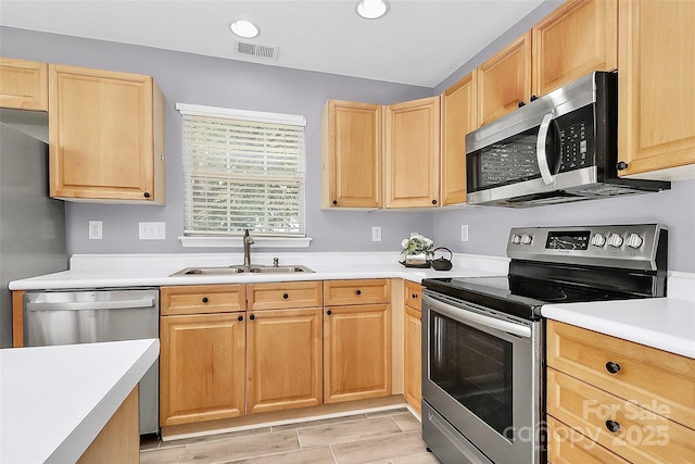 5980 Cougar Ln, Charlotte, NC 28269 - kitchen with stainless steel appliances, light brown cabinetry, light countertops, and recessed lighting