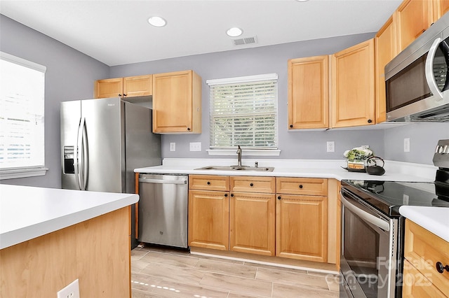 5980 Cougar Ln, Charlotte, NC 28269 - kitchen featuring stainless steel appliances, light brown cabinets, light countertops, recessed lighting, and light wood-style floors