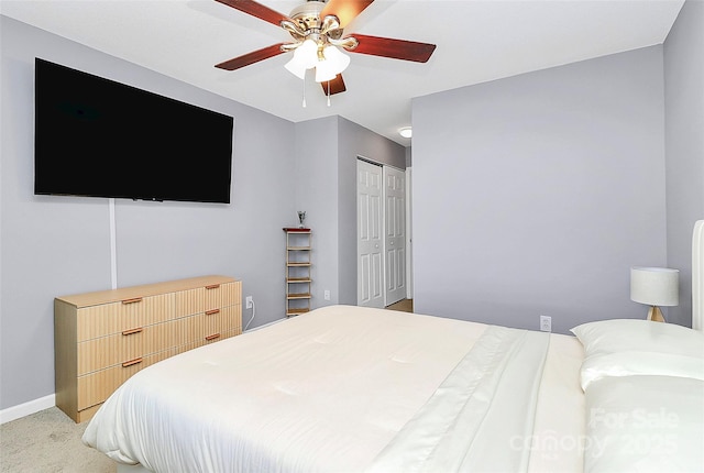 5980 Cougar Ln, Charlotte, NC 28269 - bedroom featuring a closet, ceiling fan, and light colored carpet