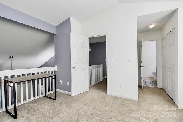 5980 Cougar Ln, Charlotte, NC 28269 - carpeted bedroom featuring vaulted ceiling and baseboards