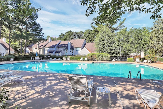 5980 Cougar Ln, Charlotte, NC 28269 - community pool featuring a patio area, view of scattered trees, and a residential view