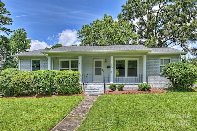 3729 Woodleaf Rd, Charlotte, NC 28205 - ranch-style home featuring brick siding, covered porch, a front yard, and roof with shingles