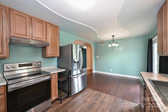 3729 Woodleaf Rd, Charlotte, NC 28205 - kitchen featuring appliances with stainless steel finishes, under cabinet range hood, dark wood-type flooring, arched walkways, and a chandelier