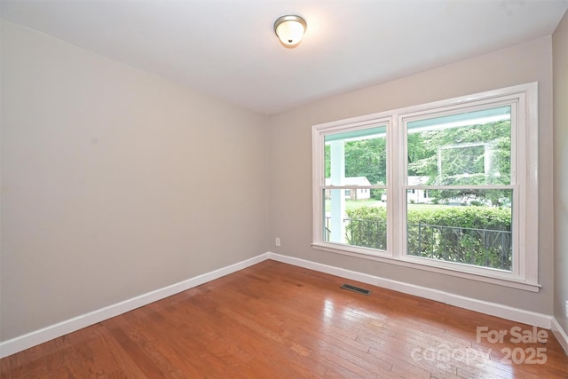 3729 Woodleaf Rd, Charlotte, NC 28205 - unfurnished room with baseboards and wood-type flooring