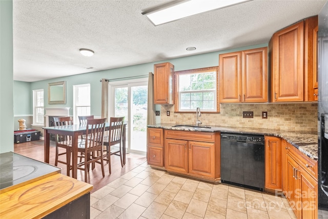 1276 Winding Path Rd, Clover, SC 29710 - kitchen with dishwasher, decorative backsplash, brown cabinetry, a textured ceiling, and stone countertops