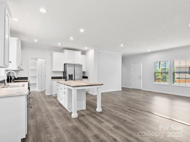 207 Walnut Branch Rd, Weaverville, NC 28787 - kitchen featuring stainless steel fridge, a kitchen island, a breakfast bar area, recessed lighting, and white cabinetry