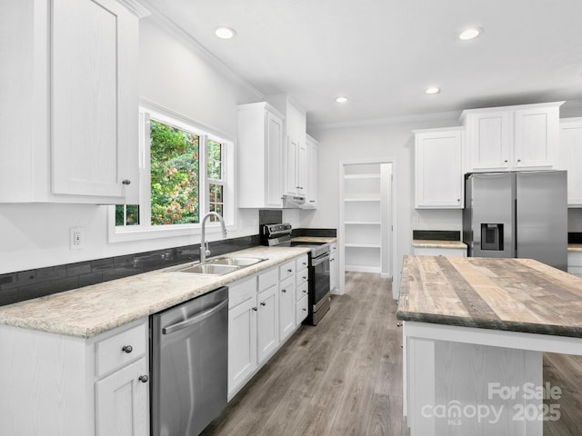 207 Walnut Branch Rd, Weaverville, NC 28787 - kitchen featuring stainless steel appliances, a center island, white cabinets, ornamental molding, and recessed lighting